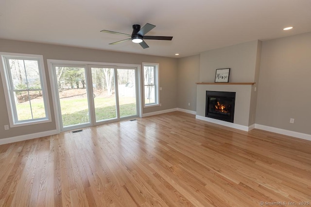 58 Killingworth Tpke, Clinton, CT 06413 - unfurnished living room featuring a glass covered fireplace, light wood-type flooring, baseboards, ceiling fan, and recessed lighting