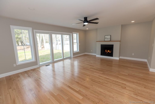 58 Killingworth Tpke, Clinton, CT 06413 - unfurnished living room with baseboards, a wealth of natural light, visible vents, and light wood finished floors