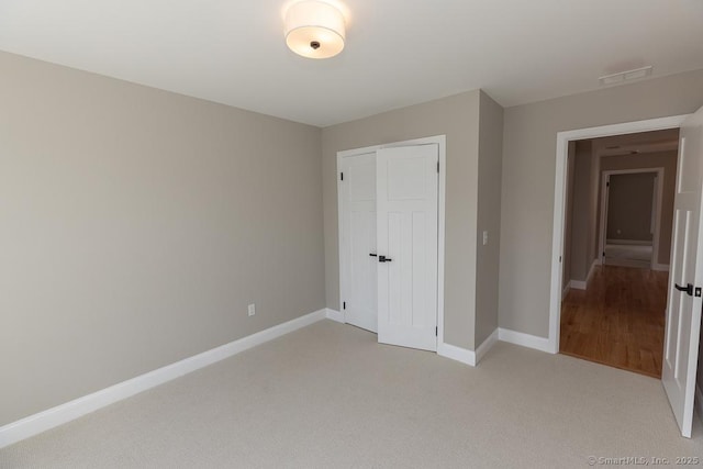 58 Killingworth Tpke, Clinton, CT 06413 - unfurnished bedroom featuring baseboards, visible vents, a closet, and light colored carpet