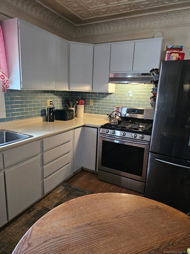 125 Mckinley Ave, Norwich, CT 06360 - kitchen featuring freestanding refrigerator, white cabinetry, gas stove, light countertops, and under cabinet range hood