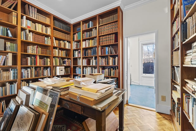 office featuring ornamental molding, baseboards, and bookshelves