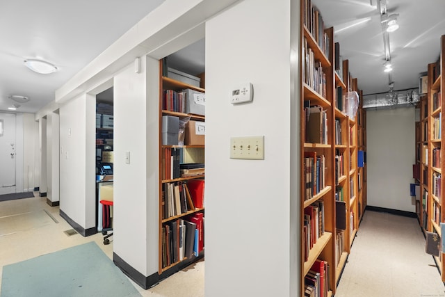 hall with tile patterned floors and baseboards