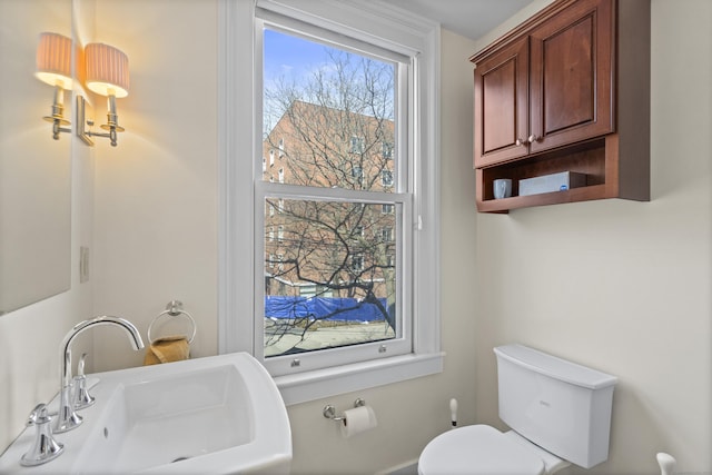 half bathroom with a sink and toilet