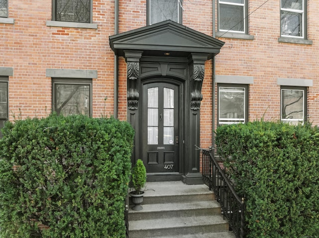 property entrance featuring brick siding