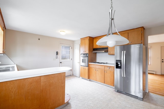kitchen featuring stainless steel appliances, under cabinet range hood, and light countertops