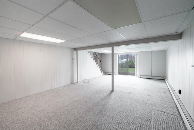 basement with a baseboard radiator, stairway, a baseboard heating unit, and carpet floors