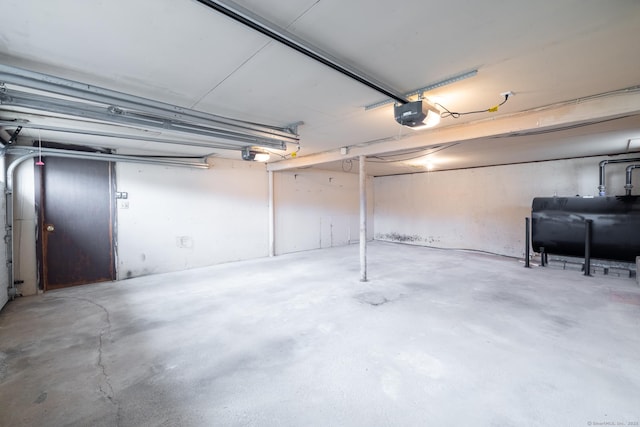 garage with a garage door opener and heating fuel