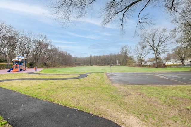 exterior space featuring a lawn, playground community, and community basketball court