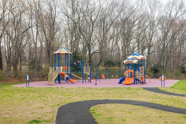 community jungle gym featuring a lawn