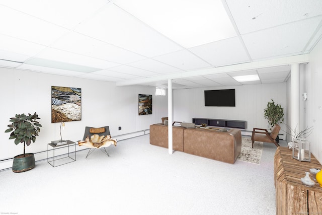 living room featuring carpet, a drop ceiling, and baseboard heating