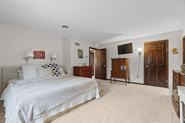 bedroom with baseboards, light carpet, and visible vents
