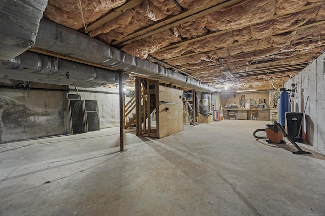 unfinished below grade area featuring water heater