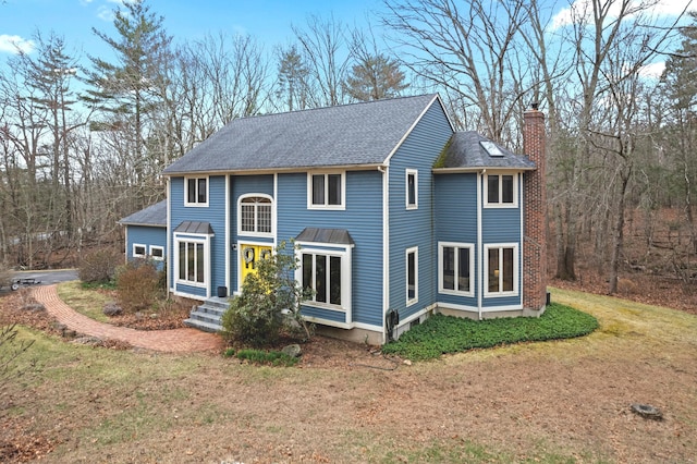 41 Boulder Ln, Mansfield, CT 06250 - colonial house featuring a chimney, a front lawn, and a shingled roof
