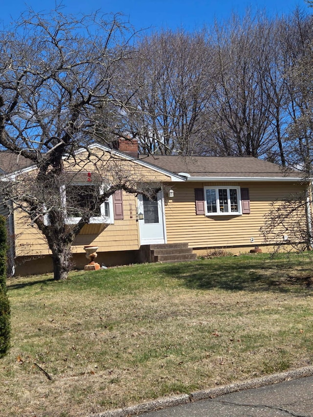 27 Payne Pl, Meriden, CT 06450 - view of front of home with a front yard, a chimney, and entry steps