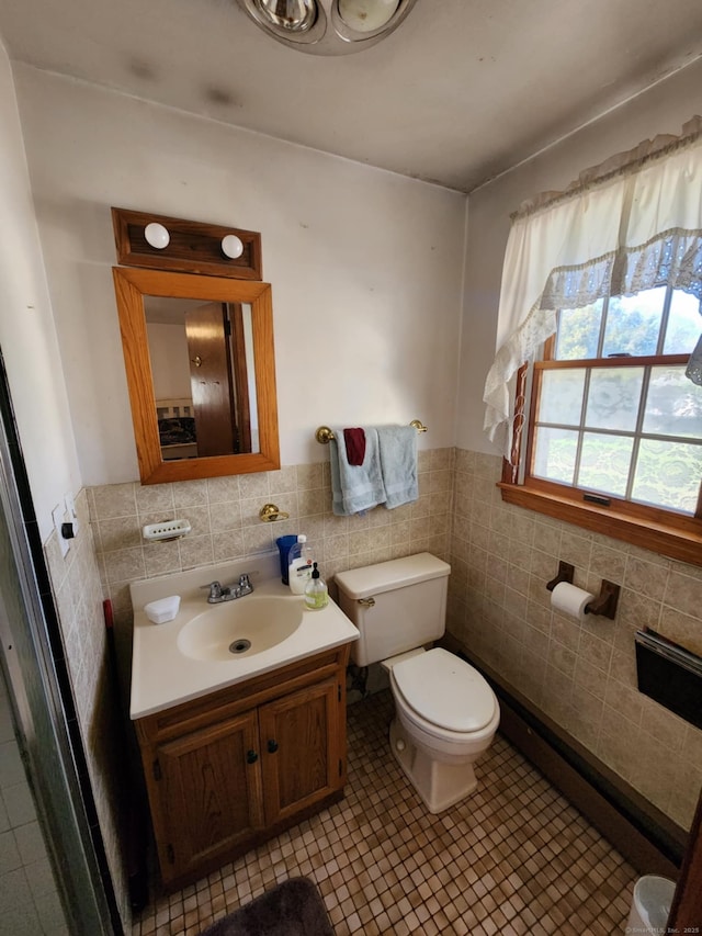 27 Payne Pl, Meriden, CT 06450 - bathroom featuring tile walls, toilet, a wainscoted wall, tile patterned flooring, and vanity
