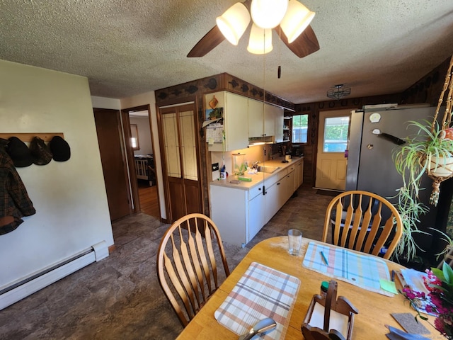 27 Payne Pl, Meriden, CT 06450 - dining area with baseboard heating, a textured ceiling, and ceiling fan