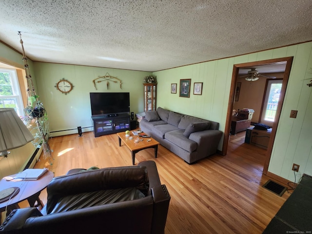 27 Payne Pl, Meriden, CT 06450 - living area with a baseboard radiator, wood finished floors, a textured ceiling, and a ceiling fan
