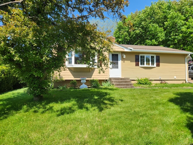 27 Payne Pl, Meriden, CT 06450 - view of front facade with a front lawn, a chimney, and entry steps