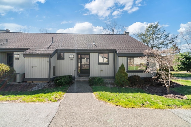 917 Heritage Vlg Unit B, Southbury, CT 06488 - view of front facade with roof with shingles, central air condition unit, and a chimney