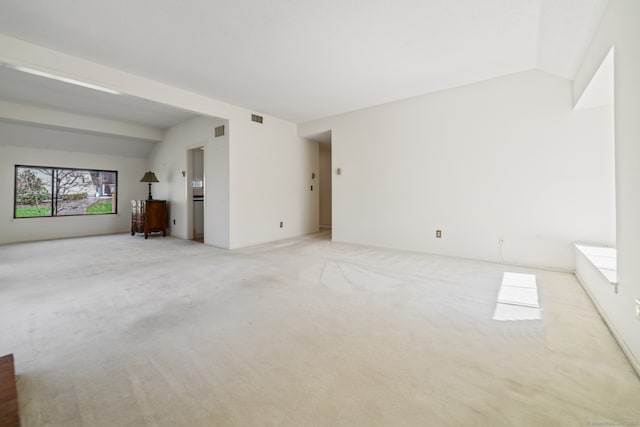 917 Heritage Vlg Unit B, Southbury, CT 06488 - unfurnished living room with lofted ceiling and light colored carpet