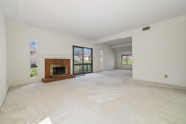 917 Heritage Vlg Unit B, Southbury, CT 06488 - unfurnished living room featuring healthy amount of natural light, carpet flooring, a fireplace, and vaulted ceiling