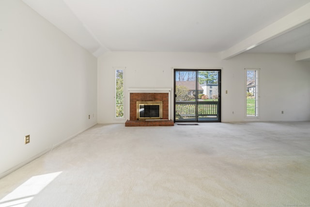 917 Heritage Vlg Unit B, Southbury, CT 06488 - unfurnished living room with plenty of natural light, light colored carpet, a fireplace, and beamed ceiling