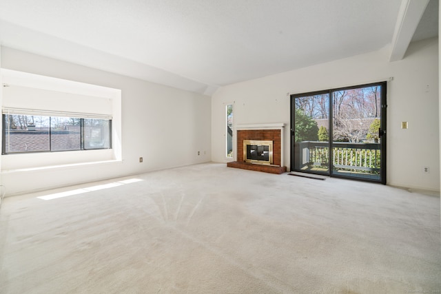 917 Heritage Vlg Unit B, Southbury, CT 06488 - unfurnished living room featuring carpet floors, a brick fireplace, and beamed ceiling