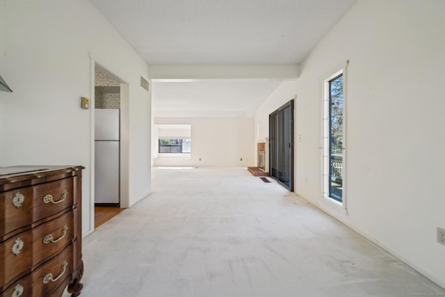 917 Heritage Vlg Unit B, Southbury, CT 06488 - corridor with plenty of natural light, light carpet, and beam ceiling