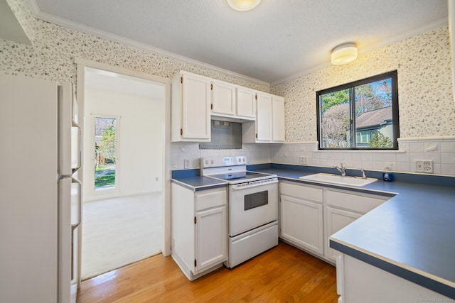 917 Heritage Vlg Unit B, Southbury, CT 06488 - kitchen featuring white appliances, a sink, crown molding, white cabinetry, and plenty of natural light