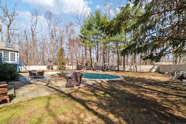 view of yard featuring a patio, a fenced in pool, and a fenced backyard