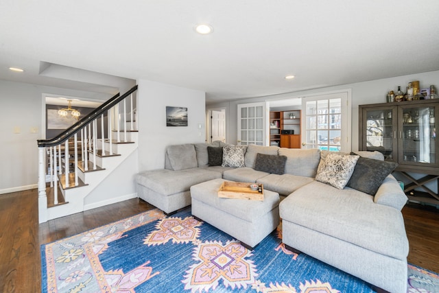 living room with stairs, recessed lighting, baseboards, a notable chandelier, and wood finished floors