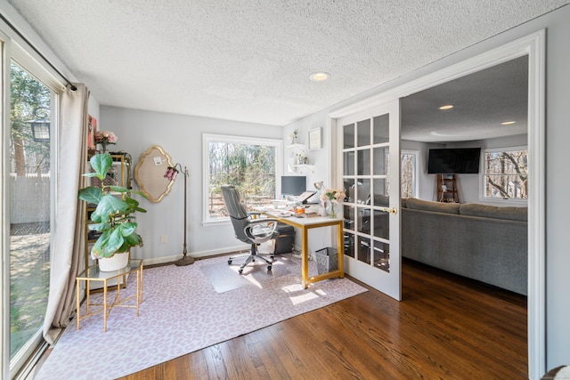 office with french doors, hardwood / wood-style flooring, baseboards, and a textured ceiling