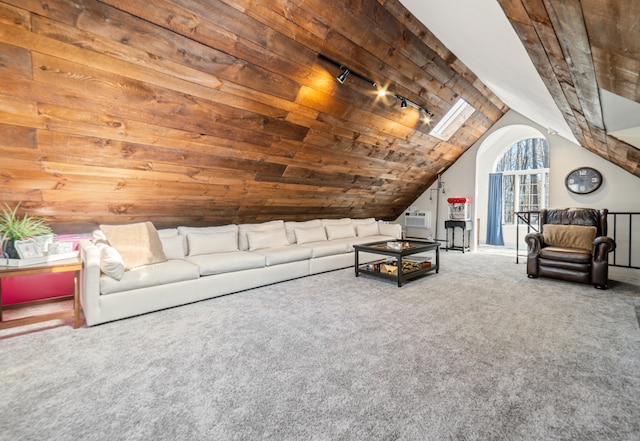 unfurnished living room featuring vaulted ceiling, wooden ceiling, rail lighting, and carpet