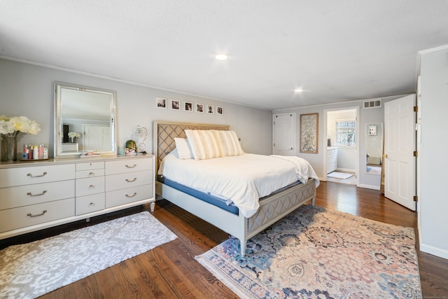 bedroom with dark wood-type flooring, baseboards, visible vents, ornamental molding, and recessed lighting