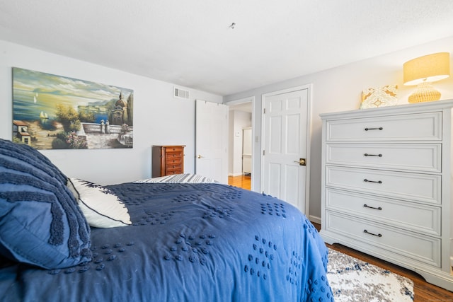 bedroom with wood finished floors and visible vents