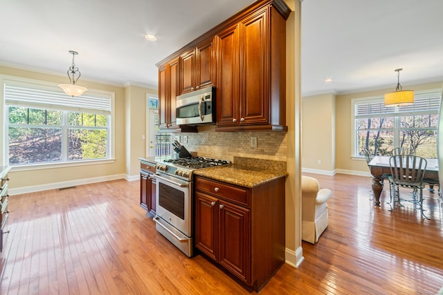 1 Winding Trl Unit 1, Middlebury, CT 06762 - kitchen featuring stainless steel appliances, light wood finished floors, baseboards, decorative backsplash, and light stone counters