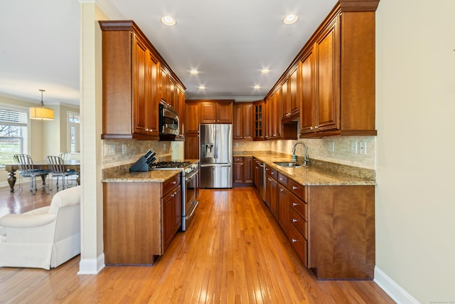 1 Winding Trl Unit 1, Middlebury, CT 06762 - kitchen featuring appliances with stainless steel finishes, a sink, light wood-style floors, light stone counters, and recessed lighting