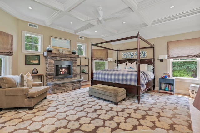6 Winthrop Hls, Weston, CT 06883 - bedroom featuring coffered ceiling, a stone fireplace, beamed ceiling, multiple windows, and ornamental molding