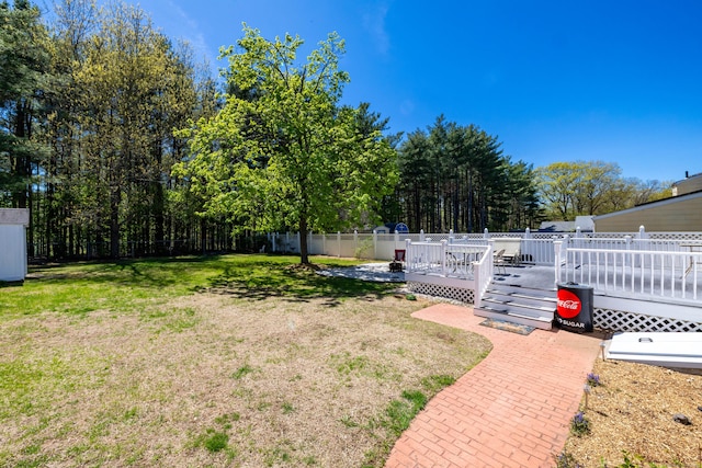 view of yard with fence and a wooden deck