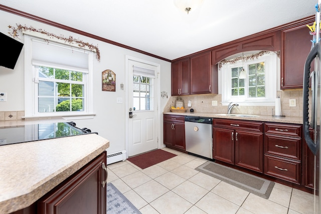 kitchen with reddish brown cabinets, a sink, dishwasher, and light countertops