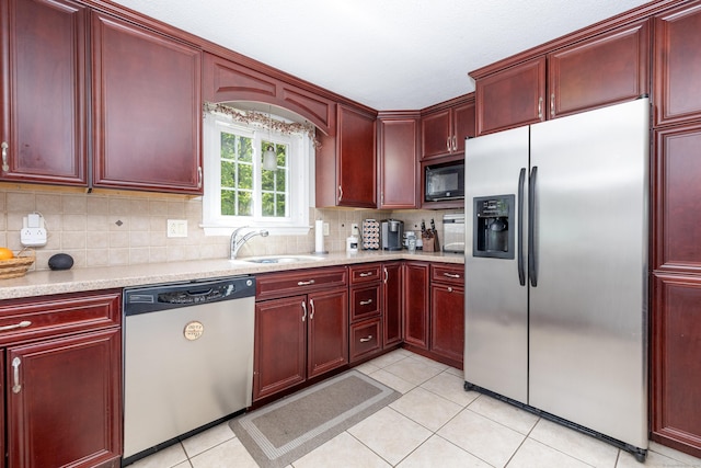 kitchen featuring a sink, appliances with stainless steel finishes, and dark brown cabinets