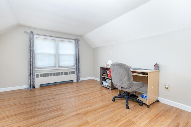 office space with wood finished floors, baseboards, radiator heating unit, and vaulted ceiling