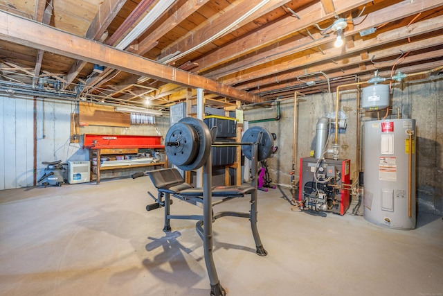 unfinished below grade area with a heating unit, a workshop area, and electric water heater