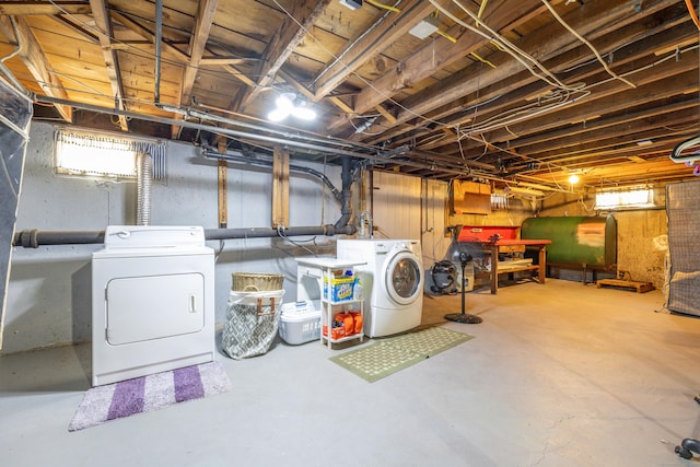 below grade area featuring separate washer and dryer, heating fuel, and a wealth of natural light