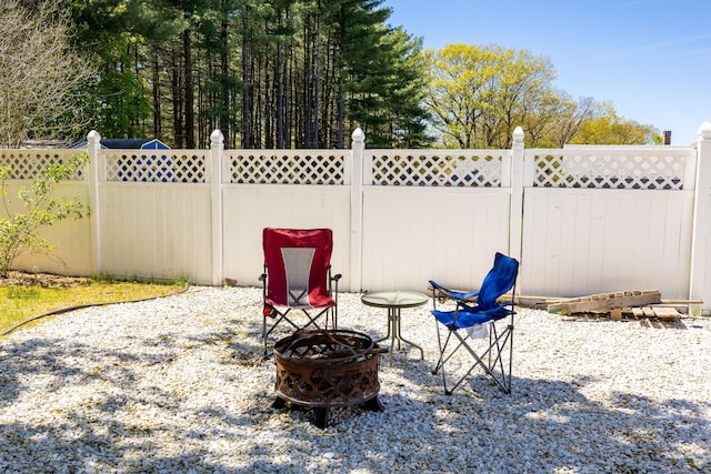 view of patio / terrace with an outdoor fire pit and fence