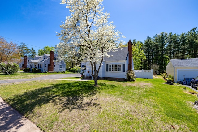 view of front of property with fence, a chimney, and a front yard