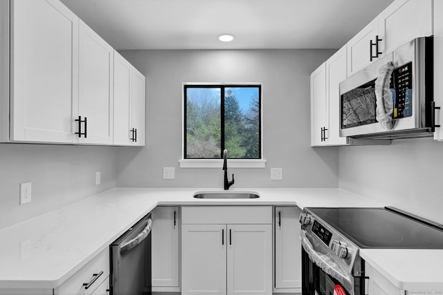 433 Heritage Vlg Unit A, Southbury, CT 06488 - kitchen featuring white cabinets, a sink, light countertops, stainless steel appliances, and recessed lighting