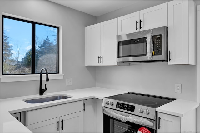 433 Heritage Vlg Unit A, Southbury, CT 06488 - kitchen with a sink, light countertops, stainless steel appliances, and white cabinetry