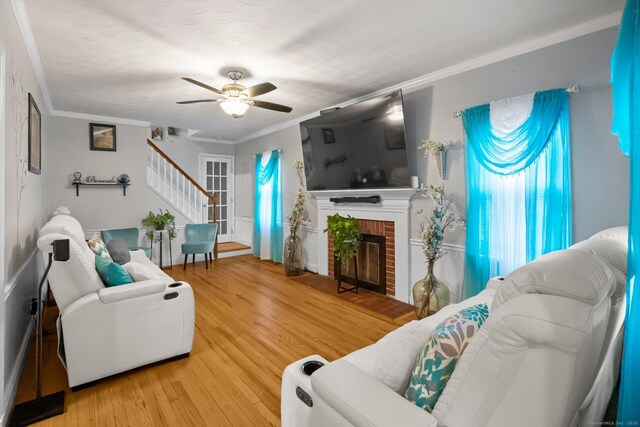 17 Winfield Dr, Stratford, CT 06615 - living room featuring stairs, a ceiling fan, crown molding, wood finished floors, and a fireplace
