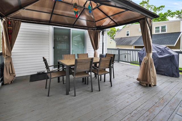 deck with a gazebo, a grill, and outdoor dining area
